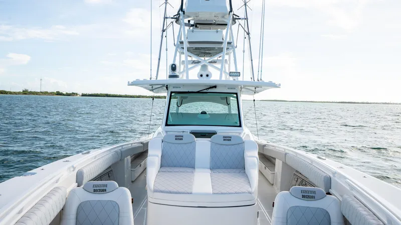 Slide: The Image of 2021 HCB 53 Sueños boat on open water, featuring luxurious seating and sleek design. - 19