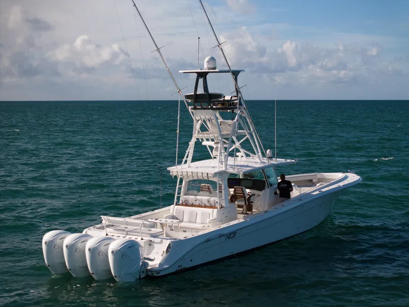 Slide: The Image of 2021 HCB 53 Sueños boat on open sea with multiple outboard engines. - 2