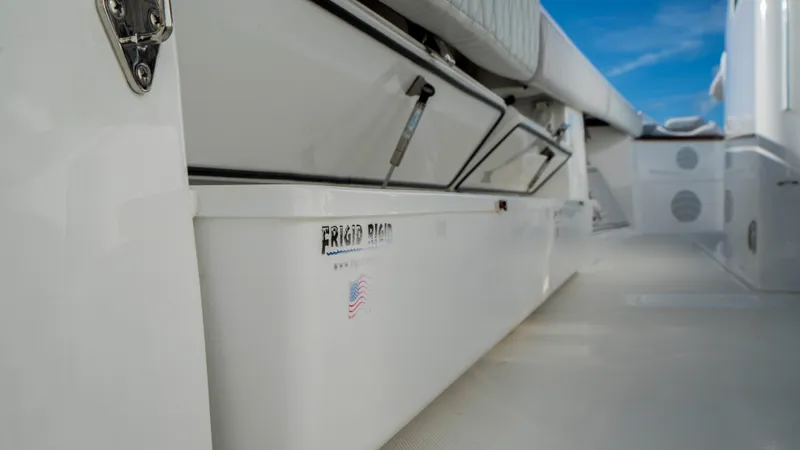 Slide: The Image of HCB 53 Sueños 2021 boat deck with storage compartments and Frigid Rigid cooler. - 24