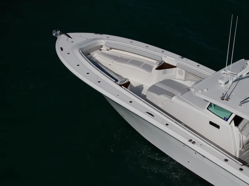 Slide: The Image of 2021 HCB 53 Sueños boat, sleek white design on water. - 4