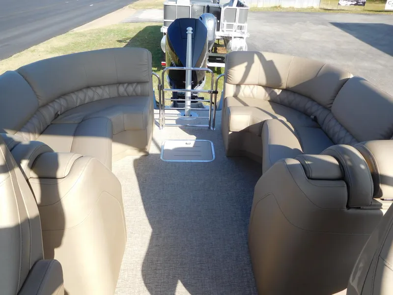 Slide: The Image of 2025 Bennington 25 QFB pontoon boat with spacious beige seating and modern design. - 12