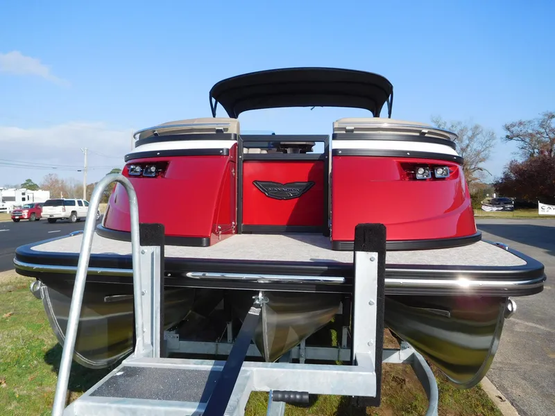 Slide: The Image of 2025 Bennington 25 QFB pontoon boat on trailer, rear view, red exterior. - 2