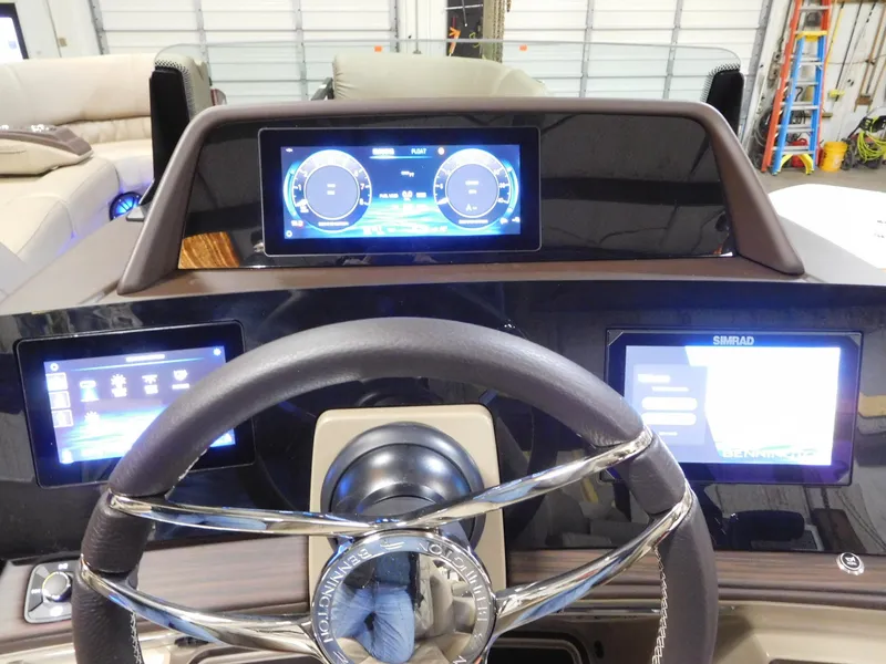 Slide: The Image of Dashboard of 2025 Bennington 25 QFB boat with digital displays and steering wheel. - 3
