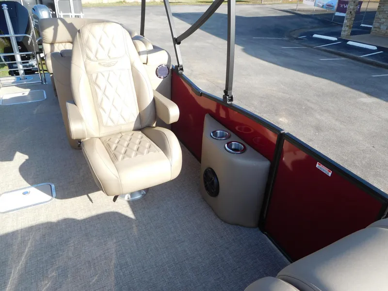 Slide: The Image of 2025 Bennington 25 QFB boat interior with beige seating and cup holders. - 8