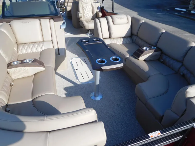 Slide: The Image of Luxurious seating on 2025 Bennington 25 QFB pontoon boat with cup holders and table. - 9