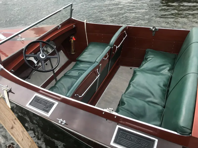 Slide: The Image of 1930 Chris-Craft Triple classic boat with green leather seats and wooden interior. - 10