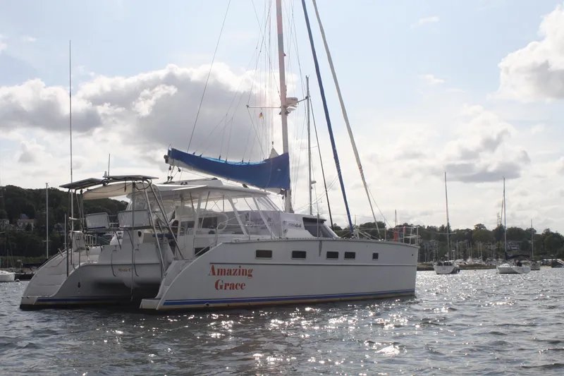 The Image of 2004 Antares PDQ 44 catamaran "Amazing Grace" anchored in a scenic harbor. - 0