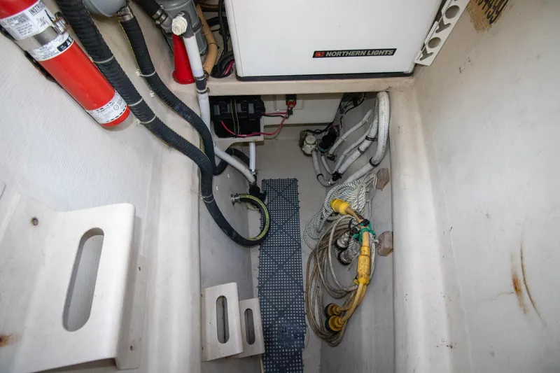 Slide: The Image of Engine compartment of 2004 Antares PDQ 44 with wiring, hoses, and fire extinguisher. - 10