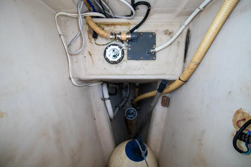 Slide: The Image of Engine compartment of a 2004 Antares PDQ 44 boat, showing hoses and mechanical components. - 13