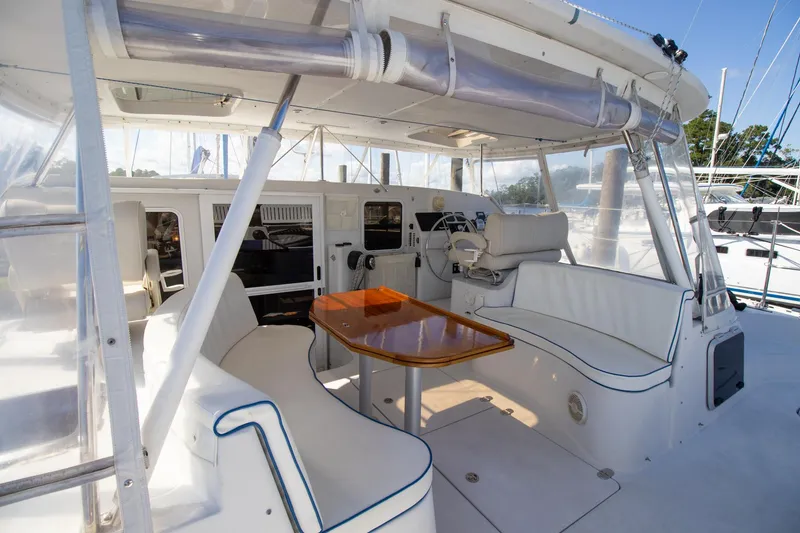 Slide: The Image of Spacious cockpit of 2004 Antares PDQ 44 yacht with seating and table. - 15