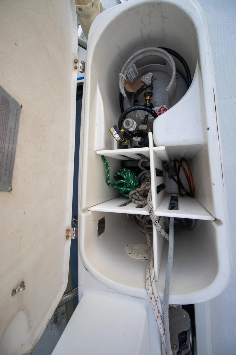 Slide: The Image of Storage compartment on a 2004 Antares PDQ 44 boat, containing ropes and equipment. - 22