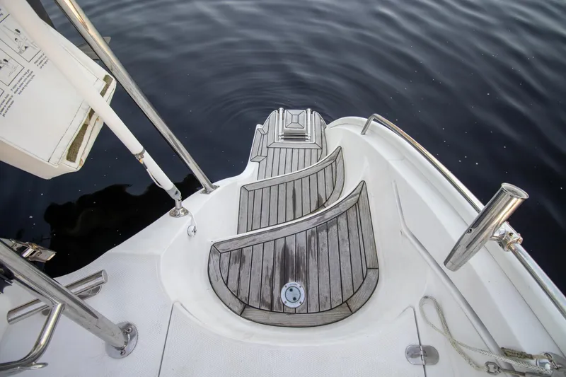 Slide: The Image of Stern view of 2004 Antares PDQ 44 yacht with wooden steps and stainless steel railings. - 24