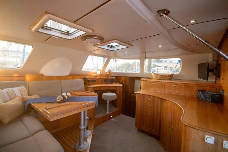 Slide: The Image of Luxurious interior of 2004 Antares PDQ 44 yacht with wooden cabinetry and seating area. - 25