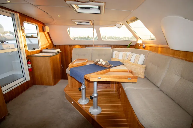 Slide: The Image of Luxurious interior of 2004 Antares PDQ 44 yacht with elegant seating and wooden accents. - 26