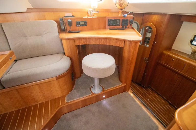 Slide: The Image of Luxurious 2004 Antares PDQ 44 yacht interior with wood finish and navigation equipment. - 28