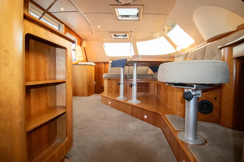 Slide: The Image of Luxurious interior of 2004 Antares PDQ 44 yacht with wooden finishes and plush seating. - 29