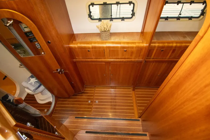 Slide: The Image of Luxurious wooden interior of 2004 Antares PDQ 44 yacht with cabinets and porthole windows. - 31