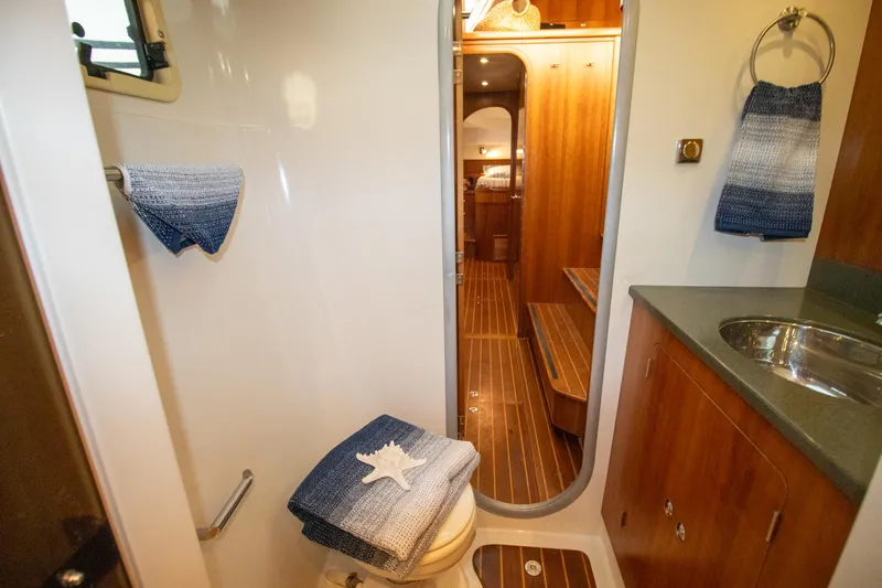 Slide: The Image of Bathroom interior of 2004 Antares PDQ 44 yacht with wooden accents and nautical decor. - 33