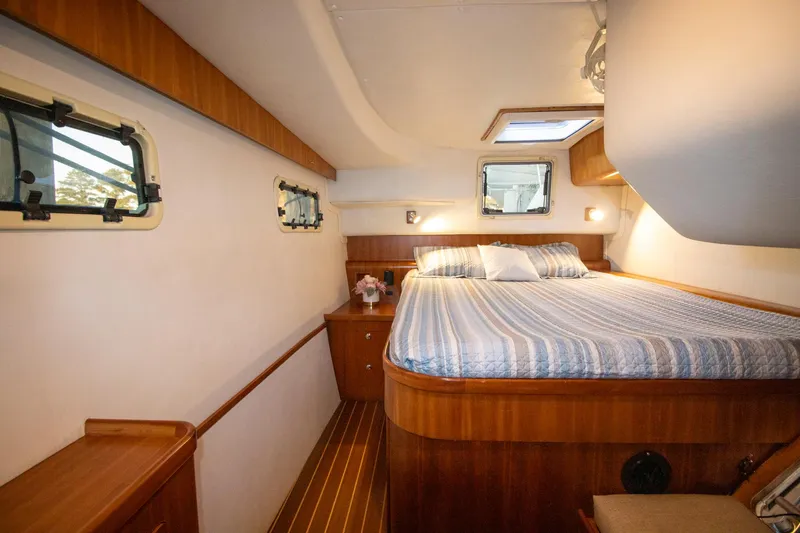 Slide: The Image of Luxurious cabin interior of 2004 Antares PDQ 44 yacht with wood accents and cozy bed. - 36