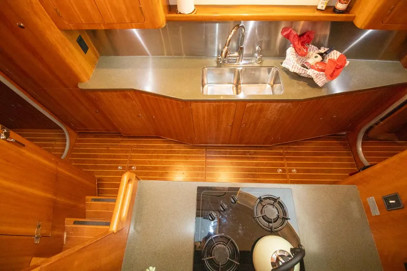 Slide: The Image of Luxurious wooden kitchen interior of 2004 Antares PDQ 44 yacht with stove and sink. - 38