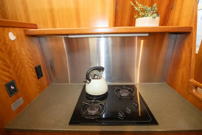 Slide: The Image of Compact kitchen in 2004 Antares PDQ 44 yacht with stove and kettle. - 39