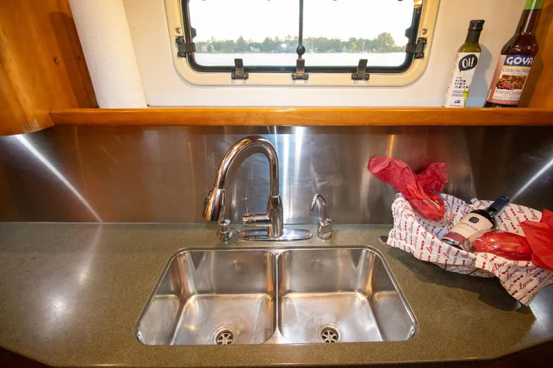 Slide: The Image of Modern kitchen sink area on 2004 Antares PDQ 44 yacht with window view. - 40