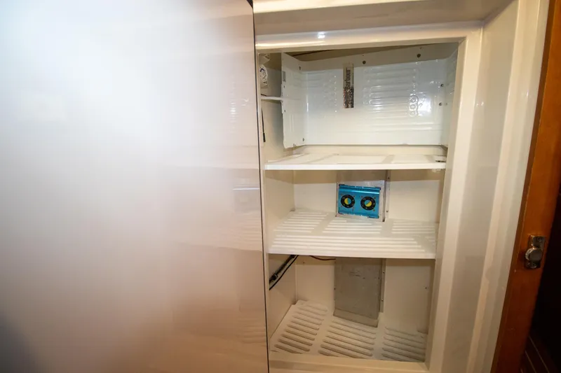 Slide: The Image of Empty refrigerator interior on Antares PDQ 44, 2004 model, with visible shelves and compartments. - 41