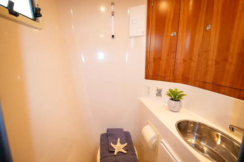 Slide: The Image of Compact bathroom in 2004 Antares PDQ 44 yacht with wooden cabinets and modern fixtures. - 45