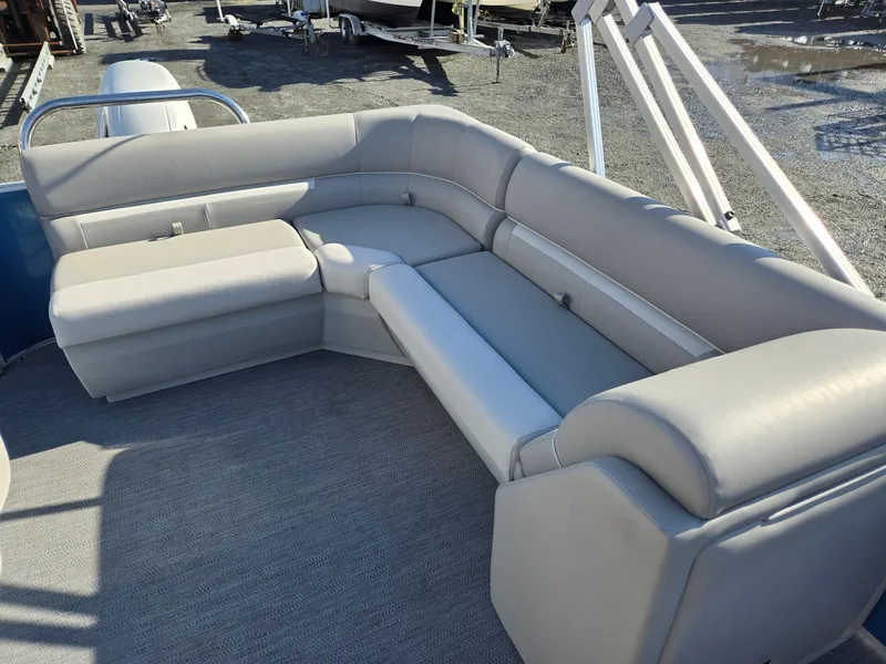 Slide: The Image of 2025 Godfrey Xperience Cruise 2086 CX boat with spacious gray seating area. - 12