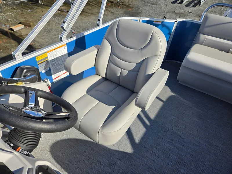 Slide: The Image of 2025 Godfrey Xperience Cruise 2086 CX boat interior with plush captain's chair and steering wheel. - 13