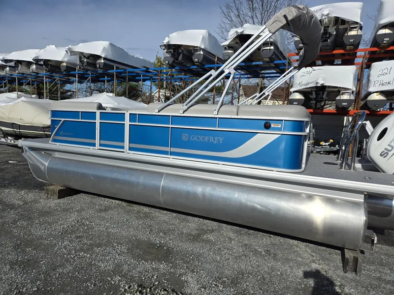 Slide: The Image of 2025 Godfrey Xperience Cruise 2086 CX pontoon boat in storage yard. - 2