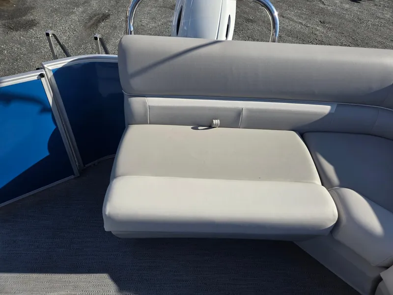 Slide: The Image of 2025 Godfrey Xperience Cruise 2086 CX boat seating with gray upholstery and blue panel. - 20