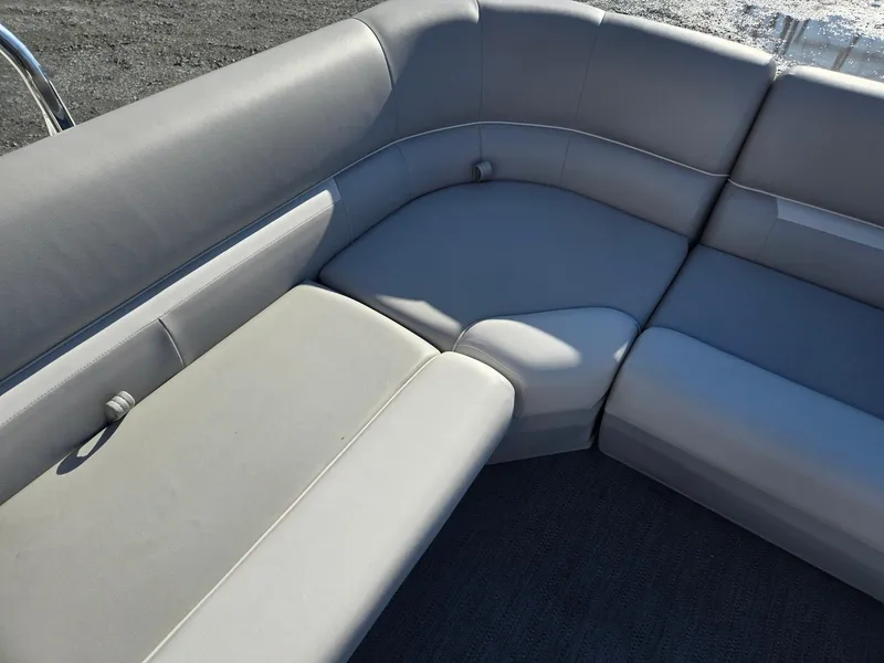 Slide: The Image of 2025 Godfrey Xperience Cruise 2086 CX boat interior with gray cushioned seating. - 21
