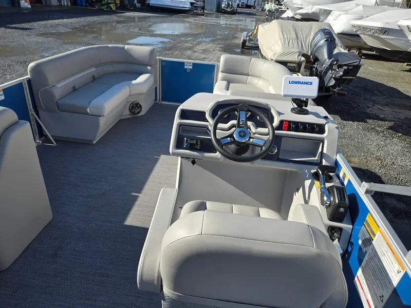 Slide: The Image of 2025 Godfrey Xperience Cruise 2086 CX pontoon boat interior with steering console and seating. - 26