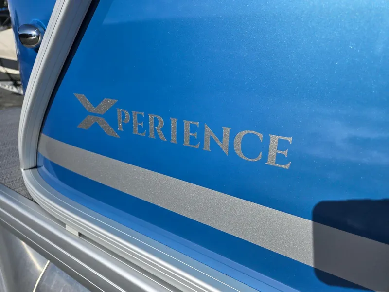 Slide: The Image of Close-up of 2025 Godfrey Xperience Cruise 2086 CX boat logo on blue surface. - 34