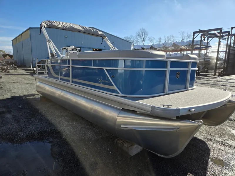 Slide: The Image of 2025 Godfrey Xperience Cruise 2086 CX pontoon boat in a storage yard. - 7