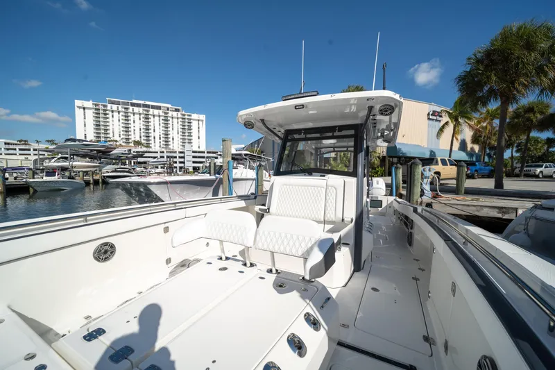 Slide: The Image of 2022 World Cat 400 CC-X boat docked at marina under clear blue sky. - 12