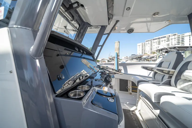 Slide: The Image of Interior of 2022 World Cat 400 CC-X boat with modern dashboard and seating. - 18