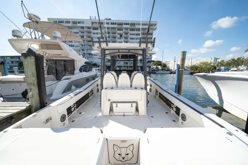 Slide: The Image of 2022 World Cat 400 CC-X boat docked at marina, clear sky background. - 31