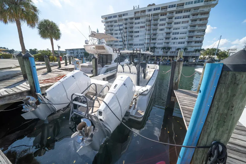 Slide: The Image of 2022 World Cat 400 CC-X boat docked at marina with building in background. - 4