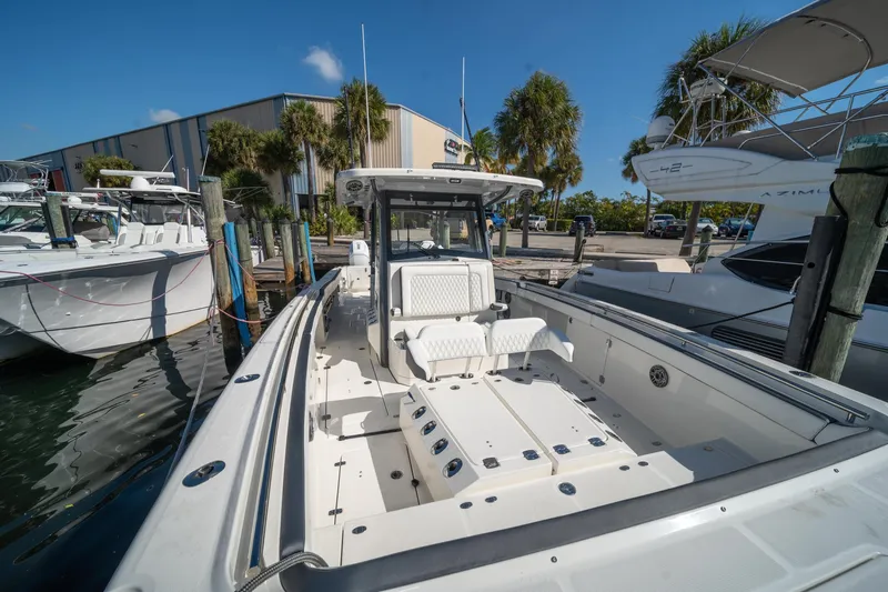 Slide: The Image of 2022 World Cat 400 CC-X boat docked at marina under clear blue sky. - 9