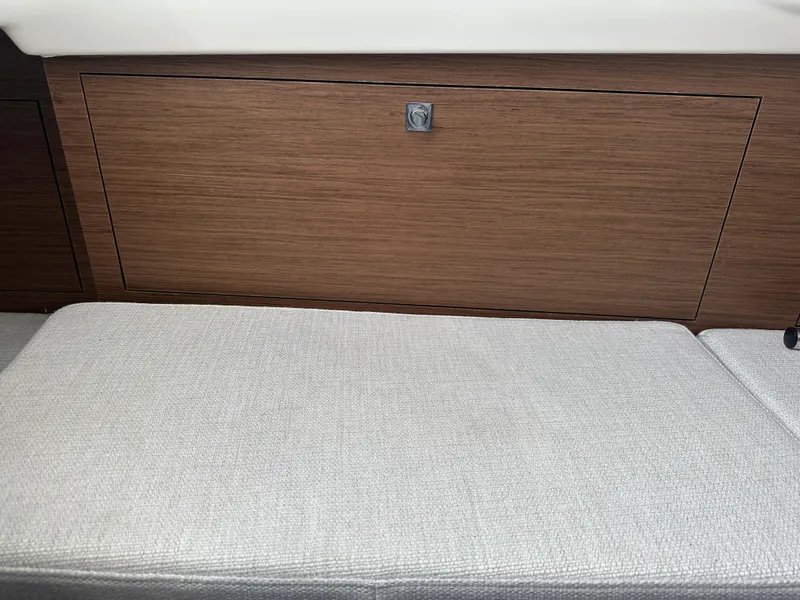 Slide: The Image of 2023 Jeanneau Leader 9.0 CC interior with wood paneling and cushioned seating. - 20