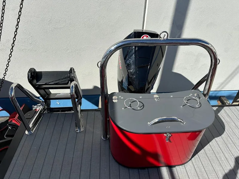 Slide: The Image of 2025 Tahoe Pontoon 2585 LTZ Entertainer boat deck with motor and railing. - 16