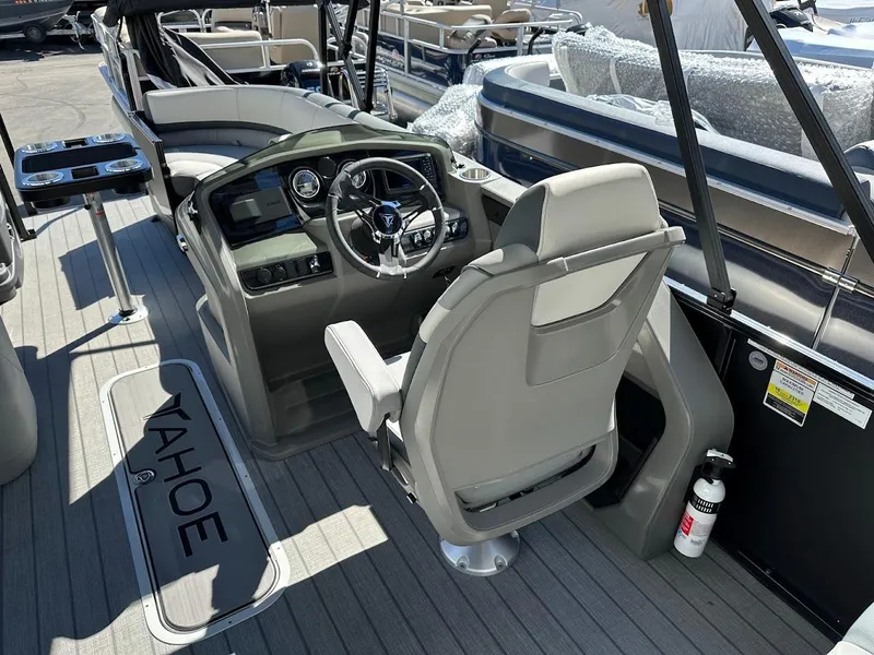 Slide: The Image of 2025 Tahoe Pontoon 2585 LTZ Entertainer boat interior with captain's chair and steering console. - 20