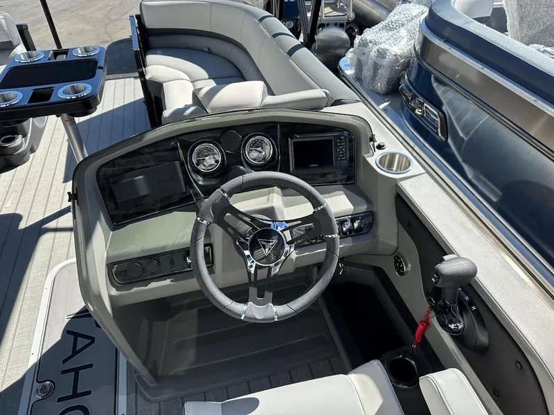 Slide: The Image of 2025 Tahoe Pontoon 2585 LTZ Entertainer boat interior with steering console and seating. - 22