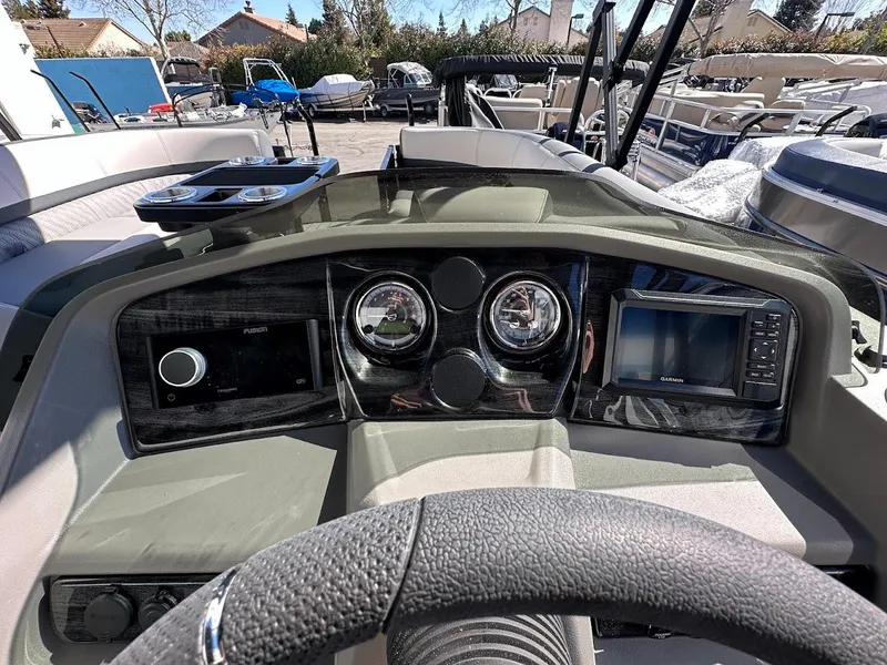 Slide: The Image of 2025 Tahoe Pontoon 2585 LTZ Entertainer dashboard with modern controls and navigation system. - 23
