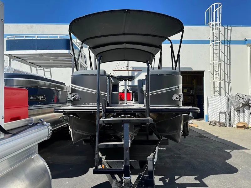 Slide: The Image of 2025 Tahoe Pontoon 2585 LTZ Entertainer boat on trailer, outdoor display. - 3