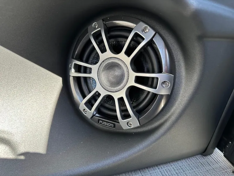 Slide: The Image of 2025 Tahoe Pontoon 2585 LTZ Entertainer speaker detail, featuring a Fusion audio system. - 35