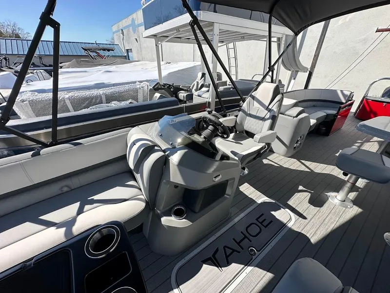 Slide: The Image of 2025 Tahoe Pontoon 2585 LTZ Entertainer interior with helm and seating area. - 7