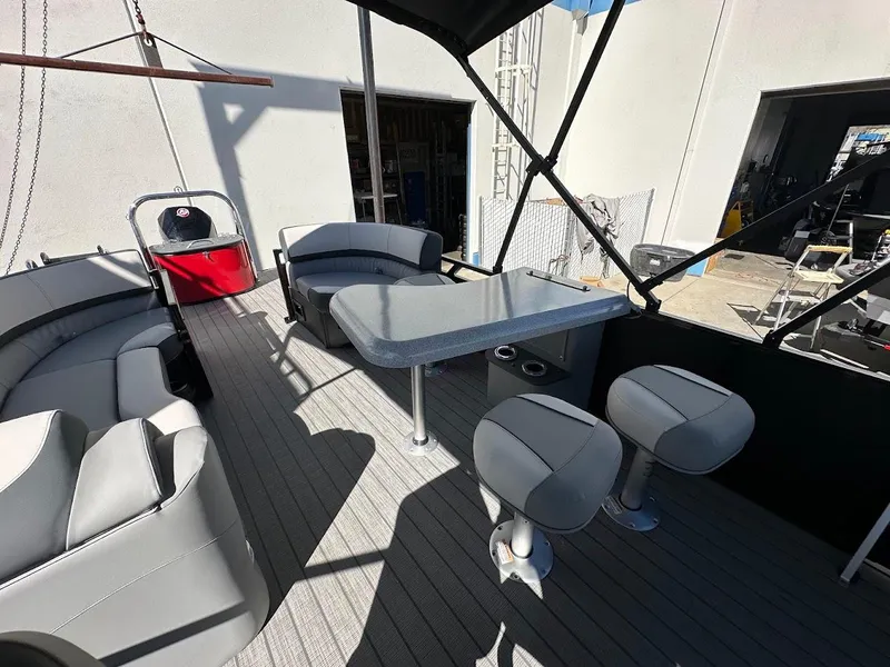 Slide: The Image of 2025 Tahoe Pontoon 2585 LTZ Entertainer with spacious seating and table setup. - 9